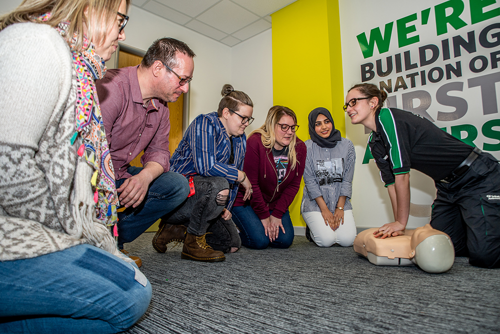 Trainer teaching CPR